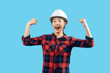 Young asian engineer female wearing helmet raise two hand with glad