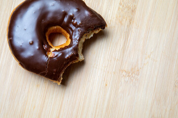 donut cake treats on a wooden table with two bites taken out
