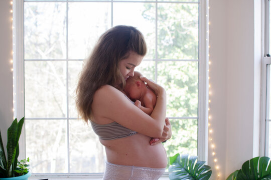 Mother With A Newborn Baby. Postpartum. Fourth Trimester. Body Positivity. Postpartum Body	