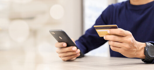 Businessman holding credit card for online shopping bill on smartphone, positive man shopping online remote payment , smart payment concept individual bank