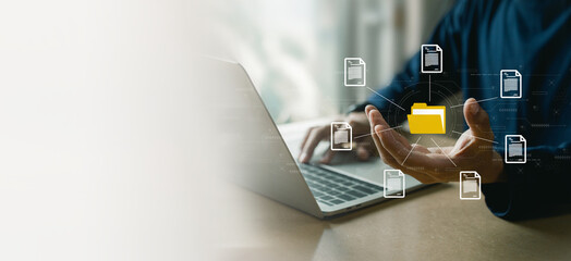 Businessman using computer laptop , holding folder and document icon software, searching and managing files online , database and document management system concept. - obrazy, fototapety, plakaty