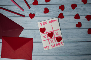 Valentines Day. Text YOU WON MY HEART and tic tac toe game Postcard craft, greeting card. DIY Step by step instruction. Making of handmade Valentine greeting card gift with your own hands.