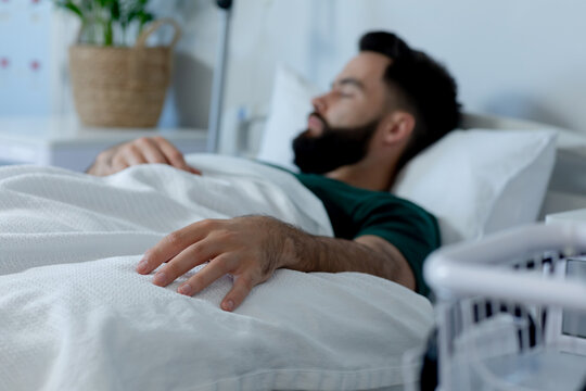 Caucasian male patient lying in bed and sleeping at hospital