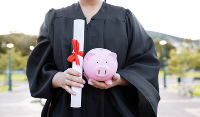 Piggy bank, saving and university diploma in hands of woman graduate with education scroll. Study...