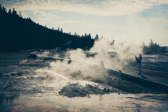 Couple of photographers walking in geyser zone.
