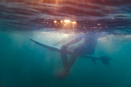 Surfer sitting on surfboard,Lombok,Indonesia