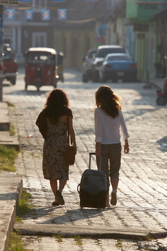 Travelers explore a colonial town.