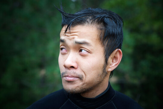 Portrait Of Young Asian Man With A Funny Look On His Face.