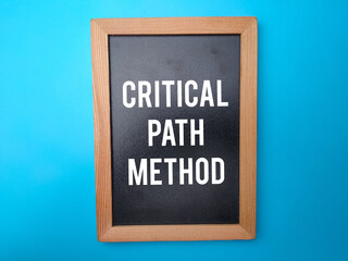 Wooden black board with the word CRITICAL PATH METHOD.