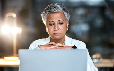 Senior woman, doctor and laptop at night thinking for healthcare solution, idea or strategy at...