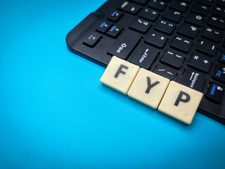 Wireless keyboard and toys word with word FYP. Business concept.