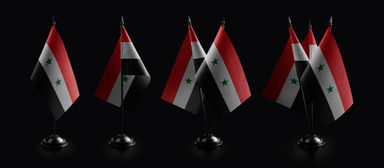 Small national flags of the Syria on a black background