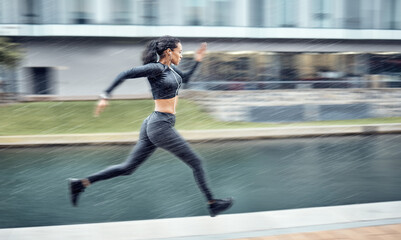 Sprinting, fast and woman running in the city for fitness, training and morning energy in Germany....