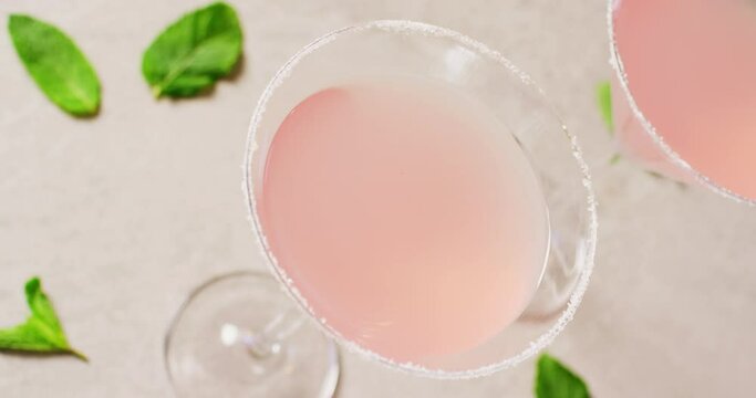 Close up of drinks with sugar over basil on white table