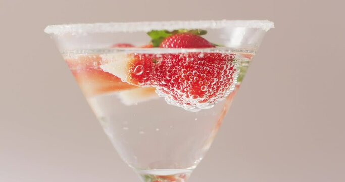 Close up of drink with sugar and strawberries on white background