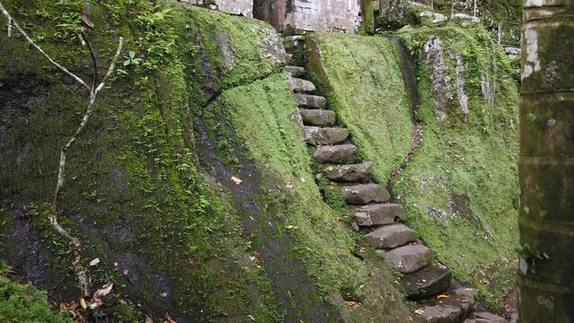 Ancient Ruins Stone Stairs and Mystical Gate at Goa Garba Temple, Bali, Indonesia, Archaeological Site in Tampaksiring Gianyar from 12th Century