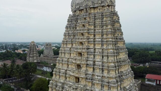 A majestic aerial view of Sri Kanchi Kamakshi Amman Temple in Kanchipuram, Tamil Nadu. Close-up of temple tower with God, and animal sculptures which are carved and sculpted mostly out of sandstone.