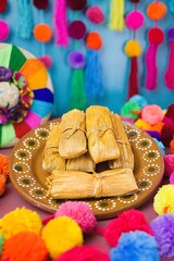 A Plate of Mexican Tamales Dinner on Traditional Mexican Handmade Clay Plates. Fiesta Dinner.