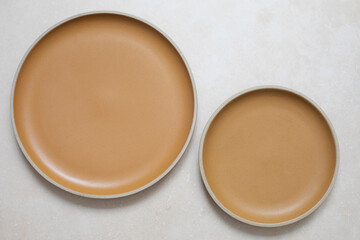 Two yellow plates on light pink