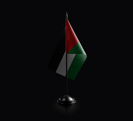 Small national flag of the Palestine on a black background