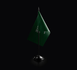 Small national flag of the Saudi Arabia on a black background