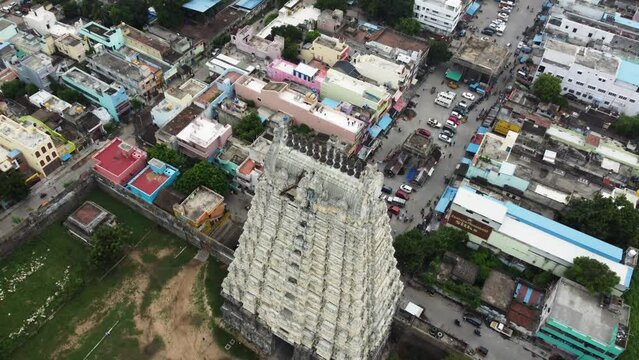 Fly over Hindu temple tower and suburban city. Aerial view of Sri Kanchi Kamakshi Amman Temple, Kanchipuram, Tamil Nadu.