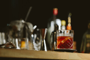 Negroni cocktail with bottles on background