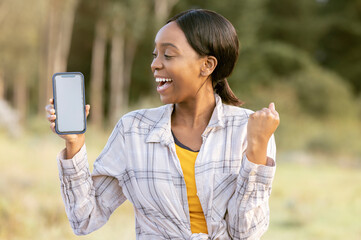 Black woman, phone and mockup display for winning, discount or sale with smile in nature. Happy...