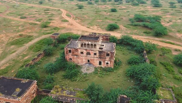 Circling drone shot of an old abandoned fort building in a forest of Gwalior , India