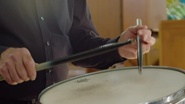 Close up male musician playing snare drum in orchestra live concert