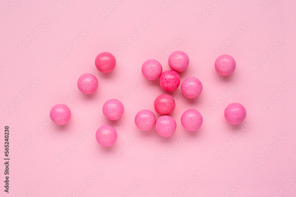 Canvas Prints Many bright chewy gumballs on pink background, flat lay