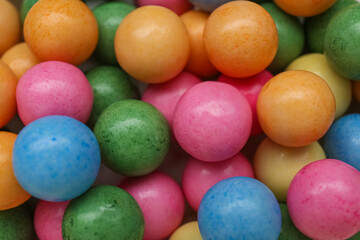 Many bright chewy gumballs as background, top view