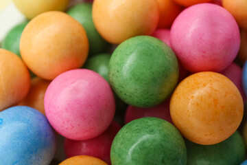 Many bright chewy gumballs as background, closeup