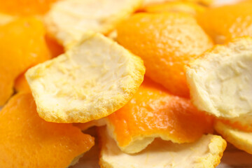 Many orange peels preparing for drying on table, closeup view