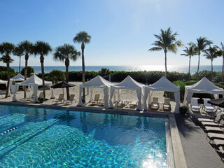 Lounge Chairs and Tent Beside Beachside Swimming Pool