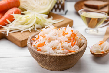 Bowl of tasty sauerkraut on white wooden table