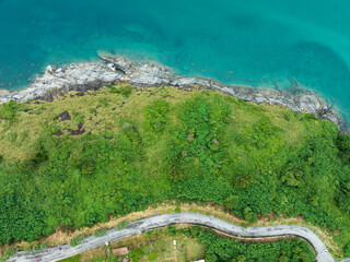 Obraz premium Aerial view of curve road along the seashore at Phuket Thailand beautiful seacoast and open sea in summer season Nature recovered Environment and Travel background