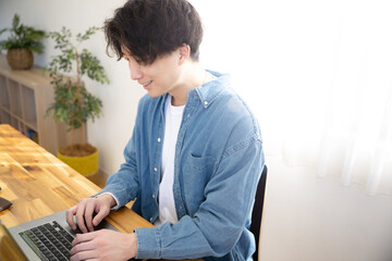 Smiling man looking at computer