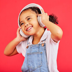 Dancing, kid and headphones for music, fun radio and girls podcast on isolated red background and...