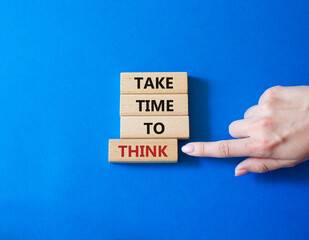 Take time to think symbol. Wooden blocks with words Take time to think. Businessman hand. Beautiful blue background. Business and Take time to think concept. Copy space.