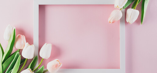 Happy women's day concept, pink tulip and white frame on pastel background. Flat lay ,top view.