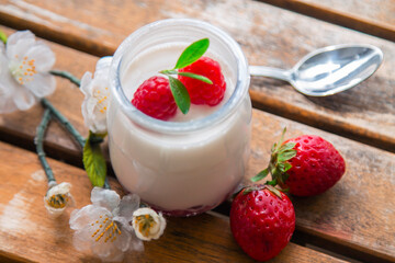Greek yogurt with blackberries and strawberries on wood