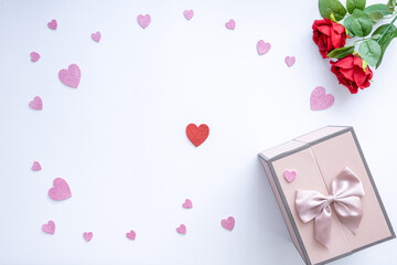 Beautiful Valentine's Day background with red hearts, red roses and gift box on white banner background. Wedding, birthday, Valentine's Day, 14 February, register of marriage concept.