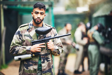 Paintball game and portrait of a man with gun and safety uniform for outdoor shooting battle....