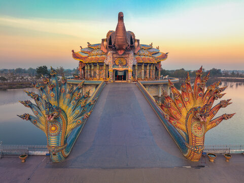 Nakhon Ratchasima, Thailand, Jan 15, 2023, Wat Ban Rai, Colorful complex with an elephant mosaic shrine in a lake, a tiled chapel headed naga statues.