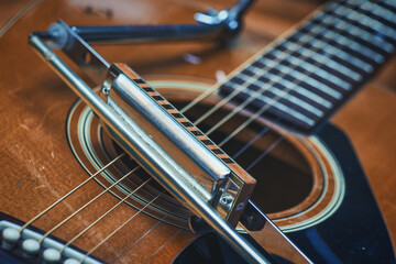 Mouth harmonica resting on acoustic guitar - obrazy, fototapety, plakaty