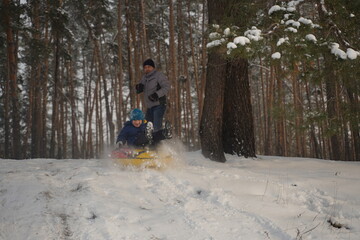 Extreme tubing descent from the mountain. Tubing flight in a splash of snow.
