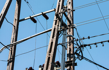 Transmission tower background. High voltage electricity pylon. Metal construction and blue sky....