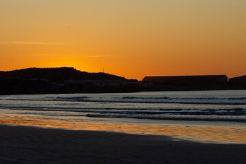 Fototapeta na wymiar On the beach of Paternoster during sunset, orange sky, water, evening, Western Cape, South Africa