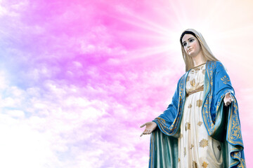 Statue of Our lady of grace virgin Mary with beautiful Sky Pastel with abstract colored background and wallpaper in sweet color. at Thailand.